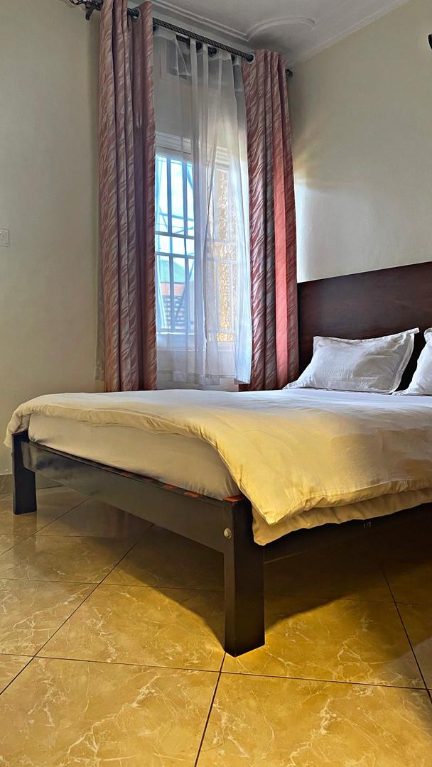 Sunlit bedroom with crisp white linens in Rubaga KD 1